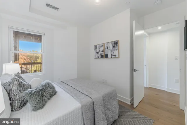 a bedroom with a bed and a painting on the wall