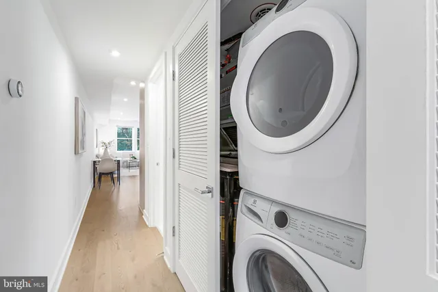 a view of a hallway with washer and dryer