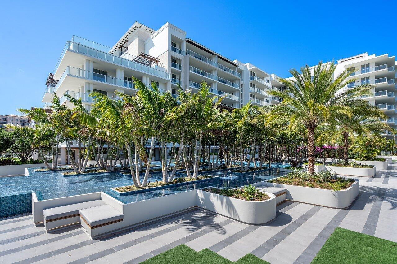 200 Southeast Mizner Boulevard, Unit 211 Boca Raton, FL 33432 - Photo 50 of 67 a front view of a house with yard and outdoor seating