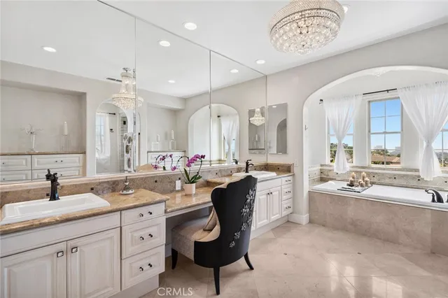 a spacious bathroom with a granite countertop sink mirror and bathtub