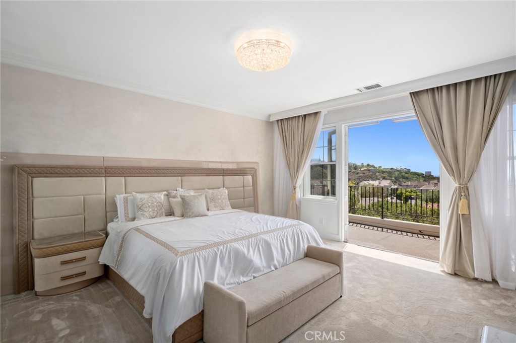 17 Lemans Newport Coast, CA 92657 - Photo 27 of 40 a bedroom with a bed and a large window with balcony view