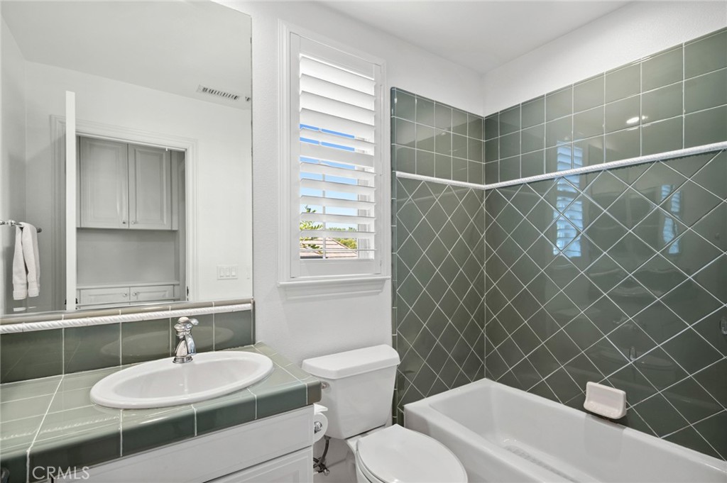 17 Lemans Newport Coast, CA 92657 - Photo 37 of 40 a bathroom with a sink a toilet and a mirror