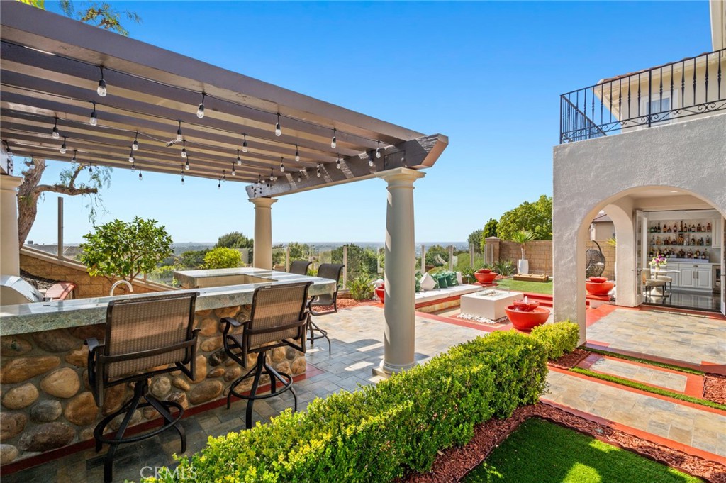 17 Lemans Newport Coast, CA 92657 - Photo 10 of 40 a view of a patio with table and chairs potted plants