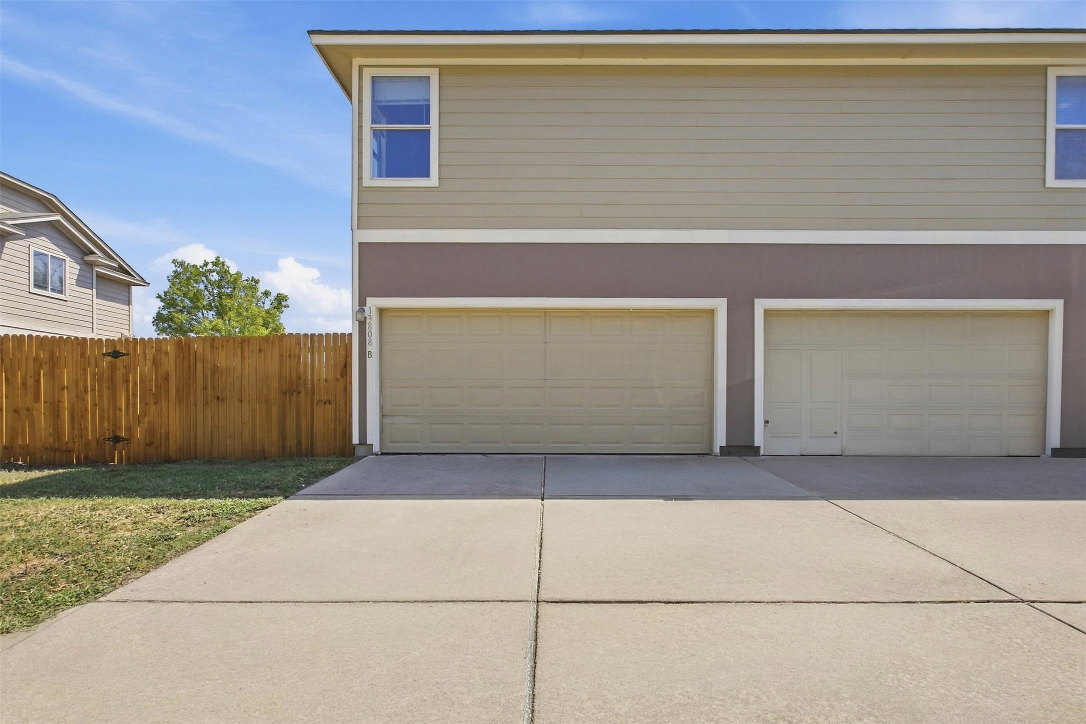 13808 Harris Ridge Boulevard, Unit B Pflugerville, TX 78660 - Photo 31 of 33 An expansive concrete driveway leads directly to the attached garages.