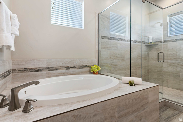 2600 Ocotillo Way, Unit 31 Santa Clara, UT 84765 - Photo 19 of 73 Soaking tub with brushed nickel fixtures, complemented by a glass-enclosed shower with a built-in shelf