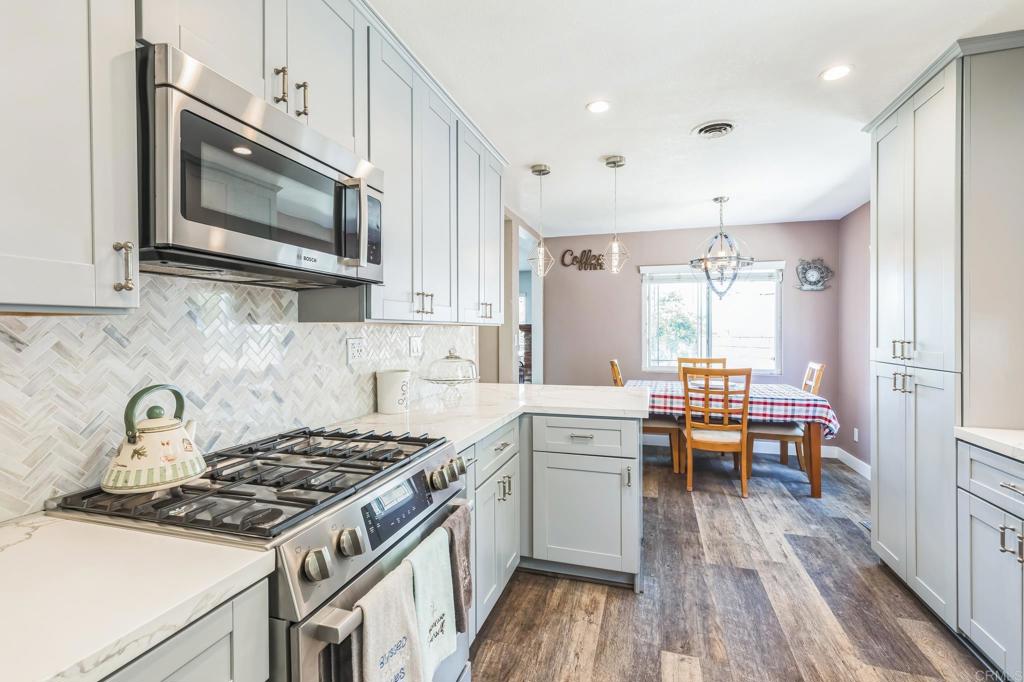 1350 Coy Court El Cajon, CA 92021 - Photo 2 of 30 a kitchen with stainless steel appliances a stove a sink and a microwave