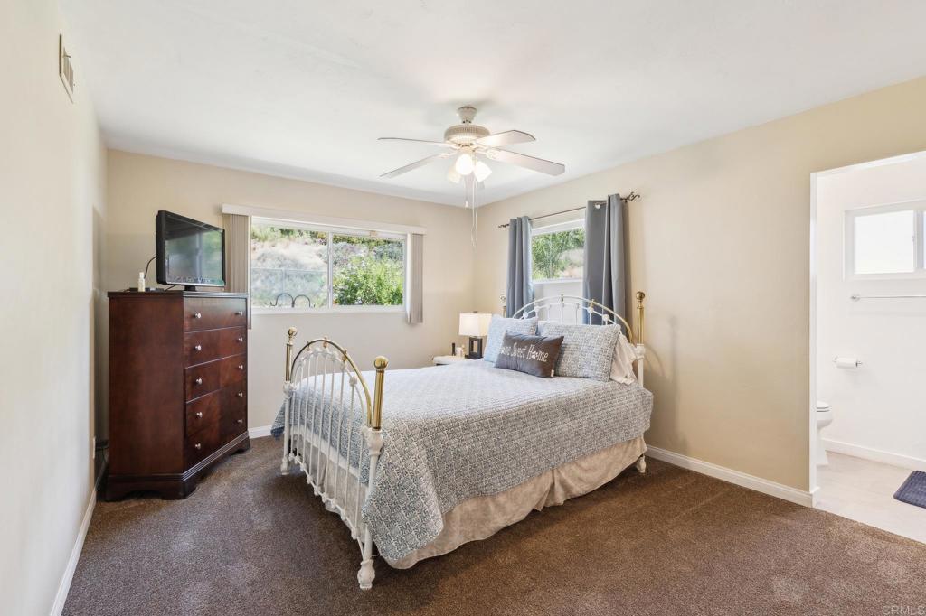 1350 Coy Court El Cajon, CA 92021 - Photo 22 of 30 a bedroom with a bed and a chandelier