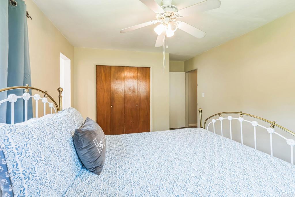1350 Coy Court El Cajon, CA 92021 - Photo 25 of 30 a bedroom with a bed and a chandelier