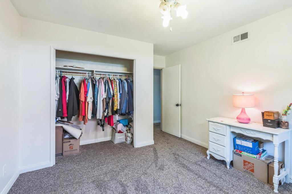 1350 Coy Court El Cajon, CA 92021 - Photo 27 of 30 a view of a room with clothes and shoes