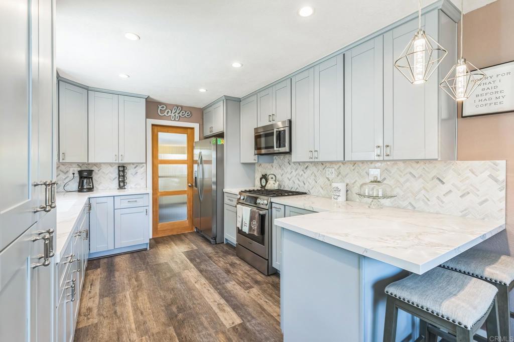 1350 Coy Court El Cajon, CA 92021 - Photo 5 of 30 a kitchen with a sink stove top oven and refrigerator