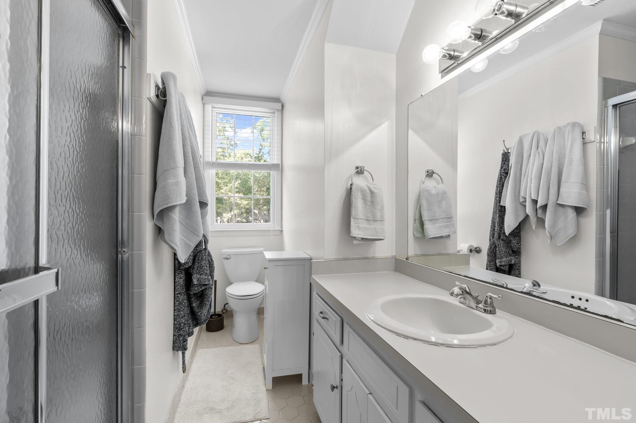 1001 Sawmill Road Raleigh, NC 27615 - Photo 15 of 48 a bathroom with a sink double vanity and a mirror