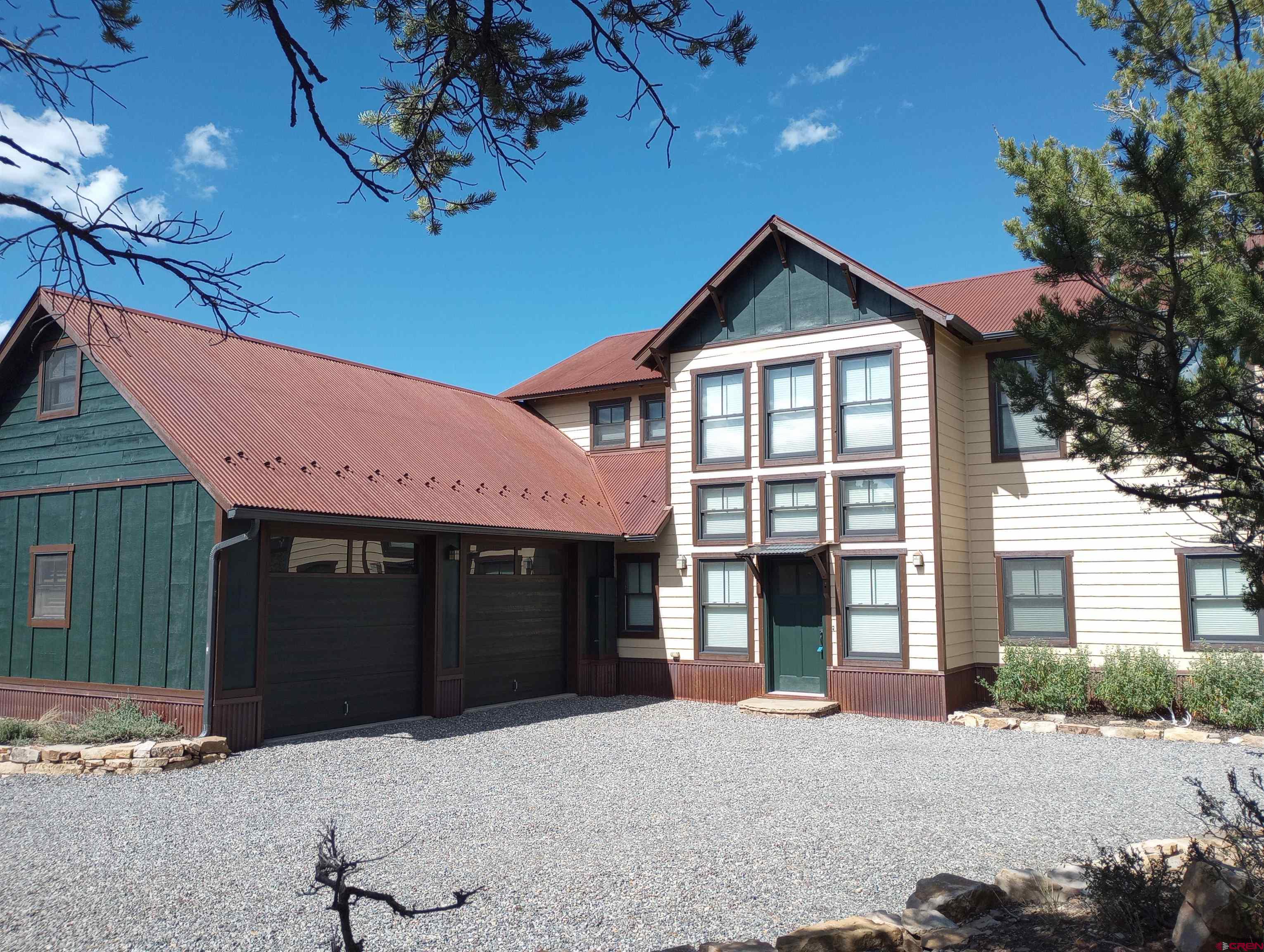 41 Oak Road Ridgway, CO 81432 - Photo 13 of 33 a front view of a house with a yard and garage