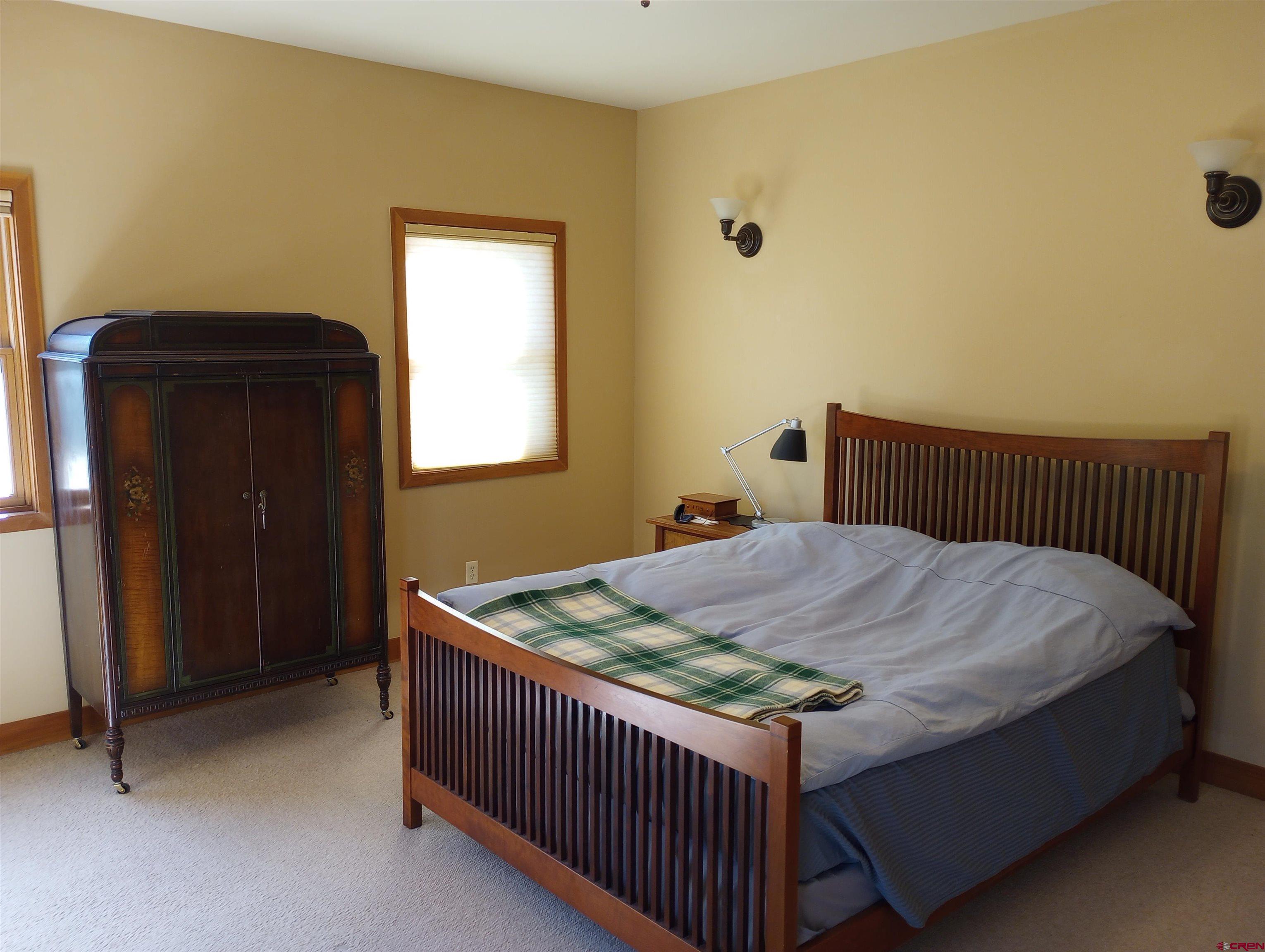 41 Oak Road Ridgway, CO 81432 - Photo 21 of 33 a bed sitting in a bedroom next to a window