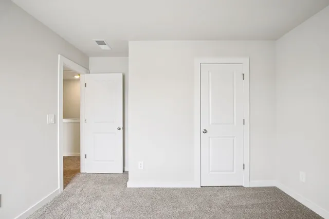 an empty room with closet area