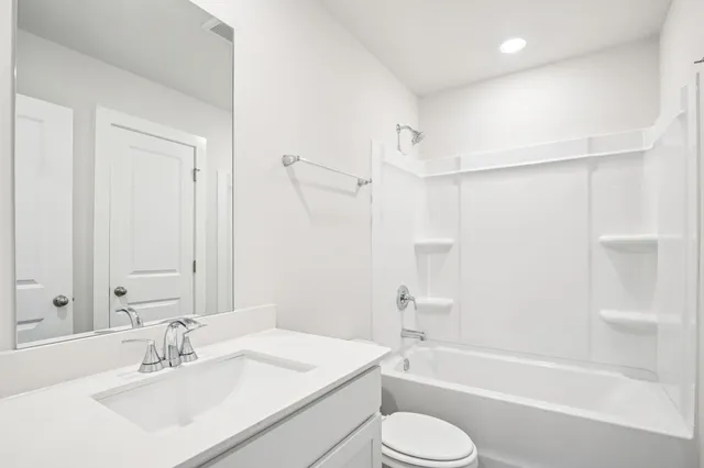 a bathroom with a sink toilet a bathtub and a vanity
