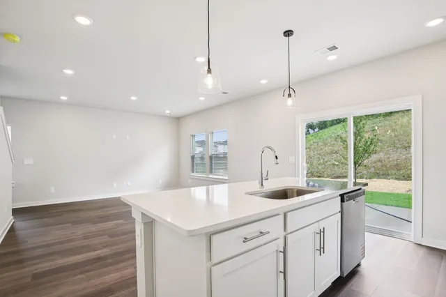 a kitchen with a sink and large window