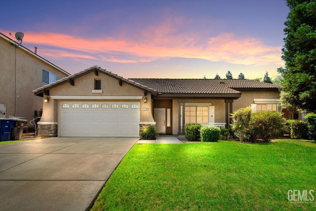 a front view of a house with a yard and garage