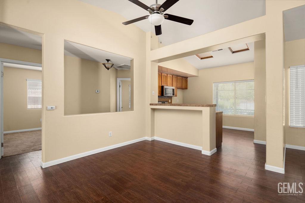 Undisclosed Address Bakersfield, CA 93312 - Photo 14 of 21 a view of a kitchen with wooden floor and a ceiling fan