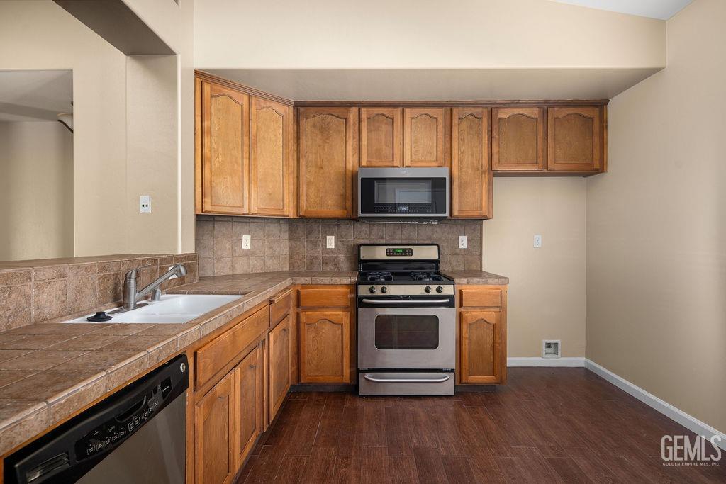 Undisclosed Address Bakersfield, CA 93312 - Photo 15 of 21 a kitchen with a sink stove top oven and microwave