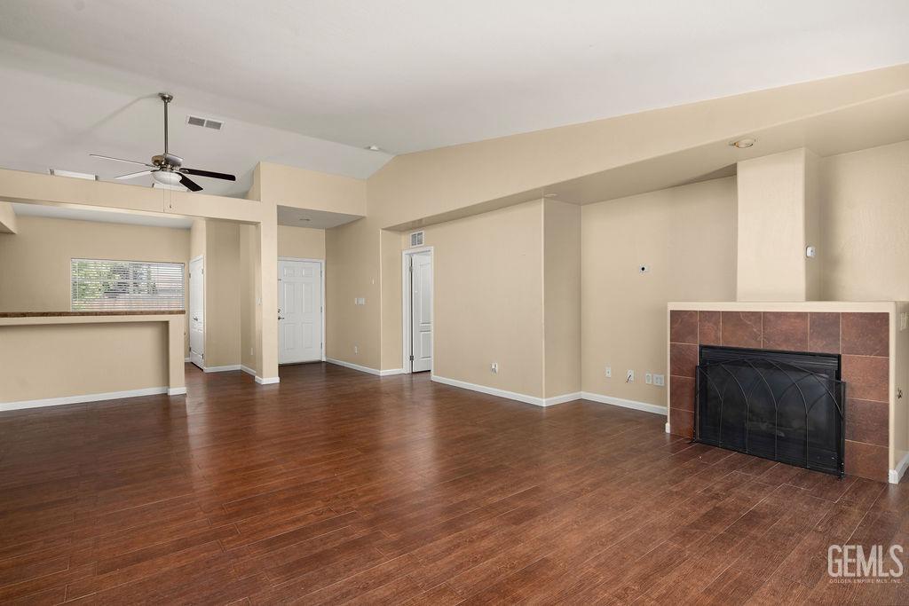 Undisclosed Address Bakersfield, CA 93312 - Photo 9 of 21 a view of an empty room with wooden floor fireplace and a window