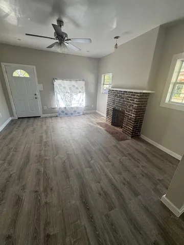 wooden floor in an empty room with a fireplace