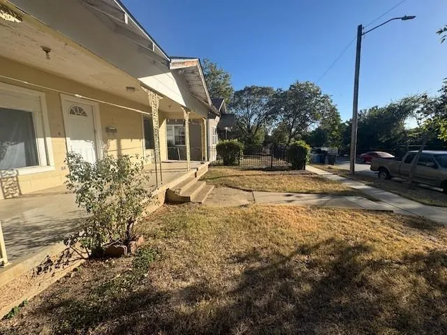 a view of a house with a yard and pathway