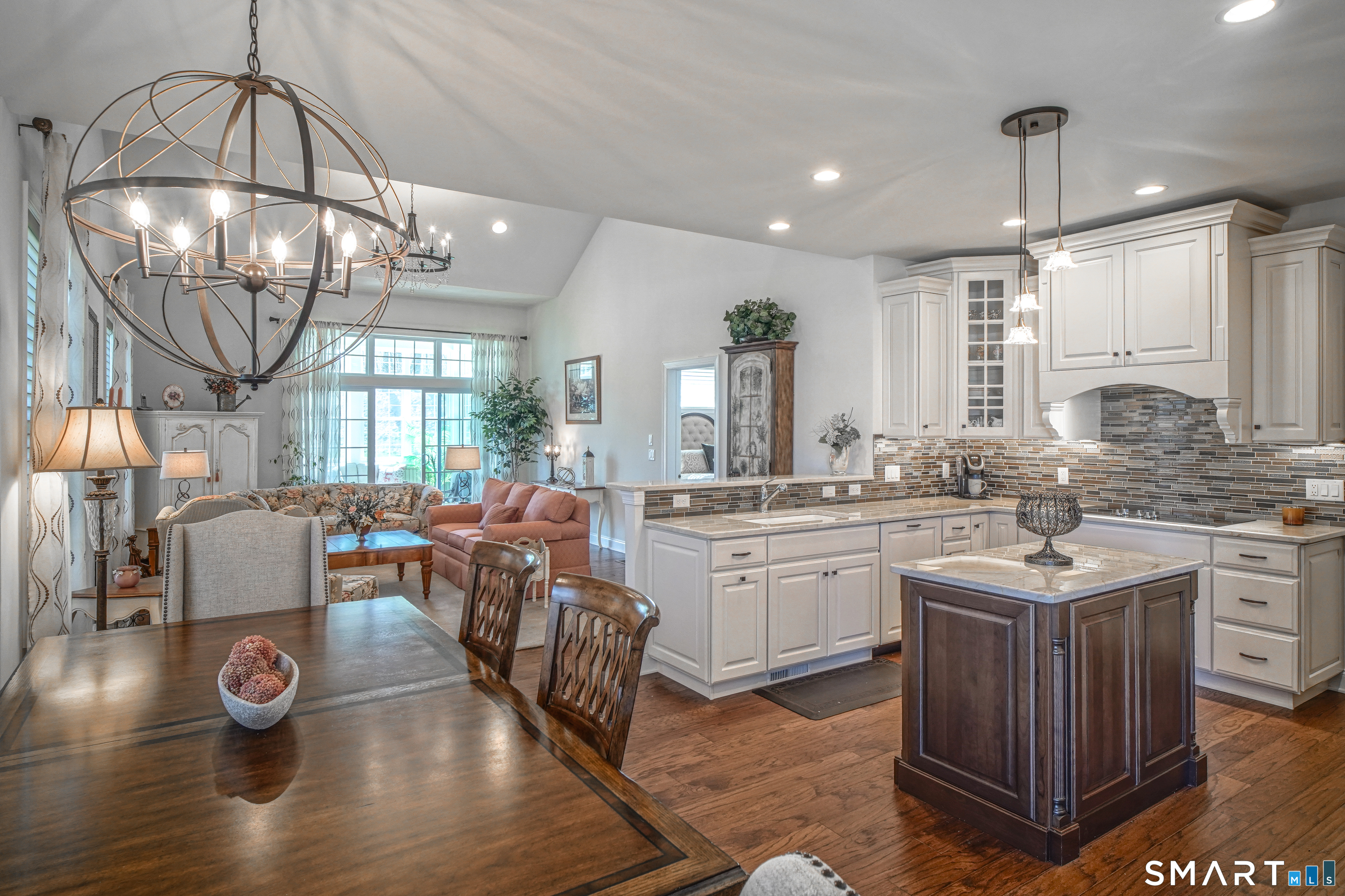 28 Tamarack Court, Unit 28 Prospect, CT 06712 - Photo 37 of 40 Experience an airy floor plan with soaring ceilings and stained hardwood floors, gourmet kitchen, dining area, and the living room.