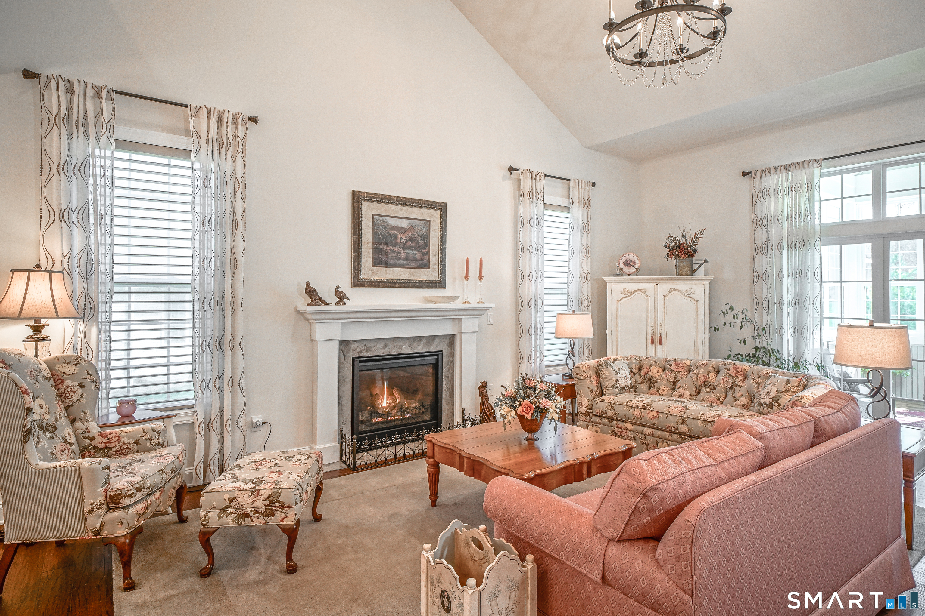 28 Tamarack Court, Unit 28 Prospect, CT 06712 - Photo 9 of 40 Enjoy gatherings in our bright living room with high ceilings and triple sliding glass doors leading to a cozy 3-season room.