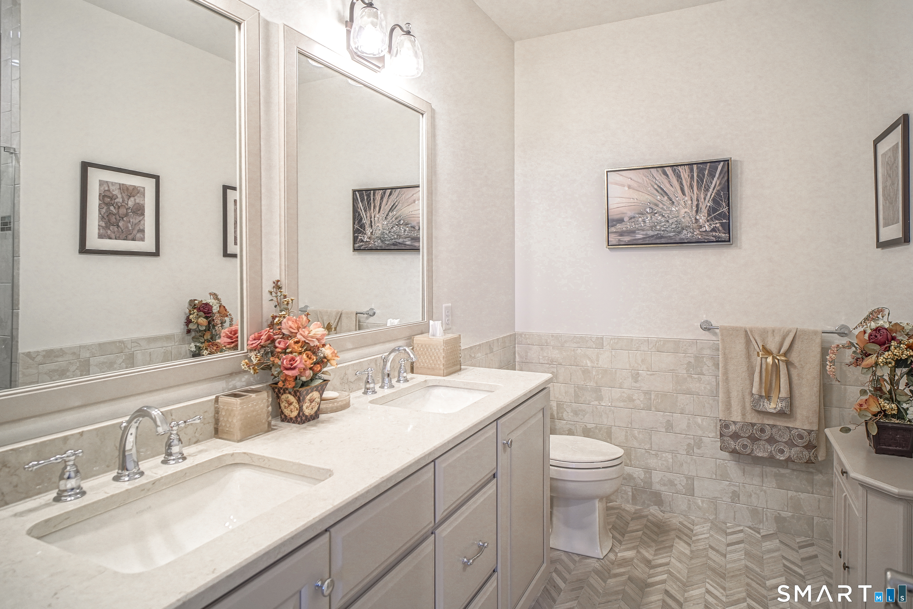 28 Tamarack Court, Unit 28 Prospect, CT 06712 - Photo 14 of 40 Designer Bath: Straight from a magazine, showcasing herringbone tile floors, a decorative tiled shower with a built-in seat, a double-sink vanity with high-end cabinetry, and premium fixtures.