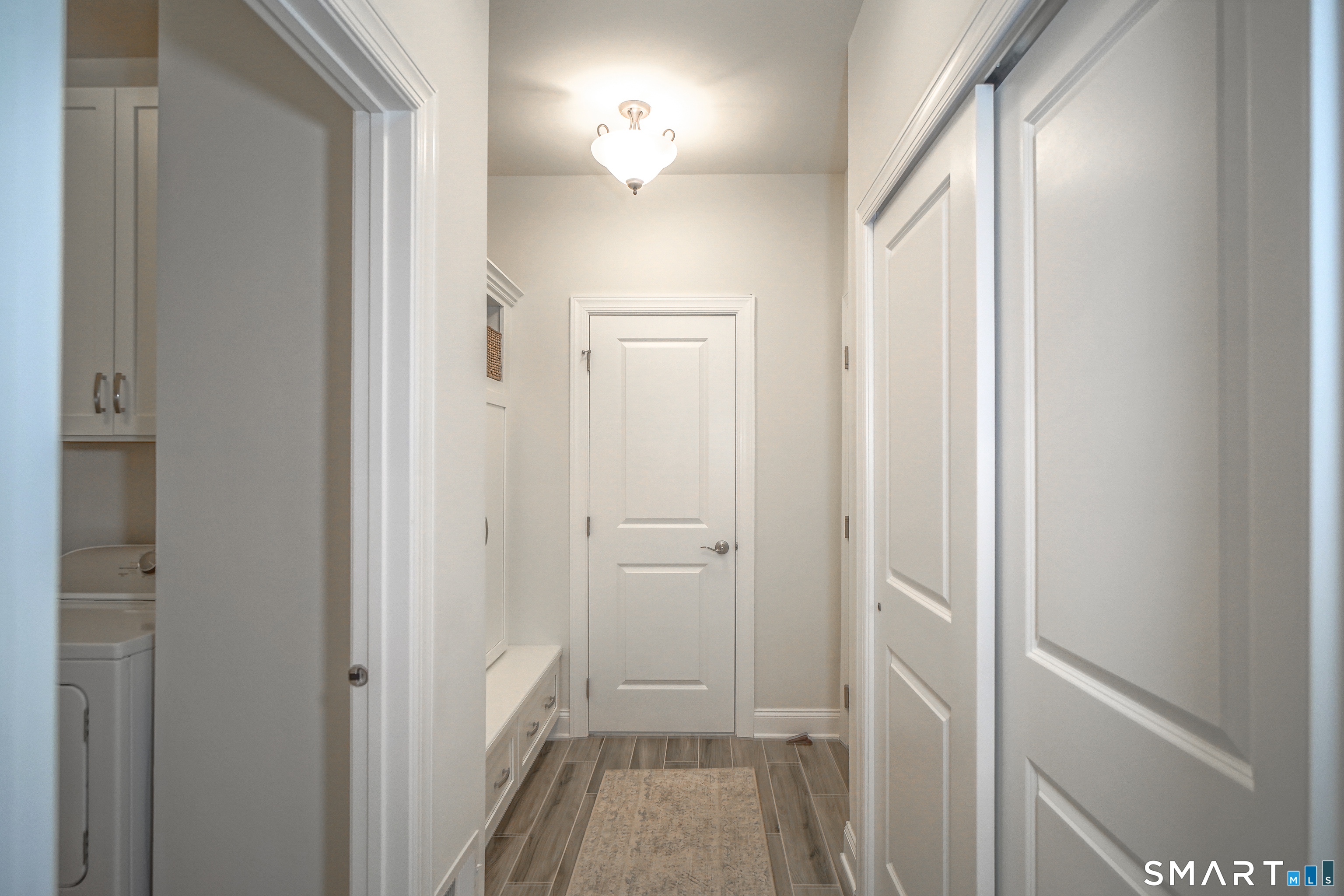28 Tamarack Court, Unit 28 Prospect, CT 06712 - Photo 19 of 40 The hallway off the kitchen to the garage includes a mud room/pantry with built-ins.