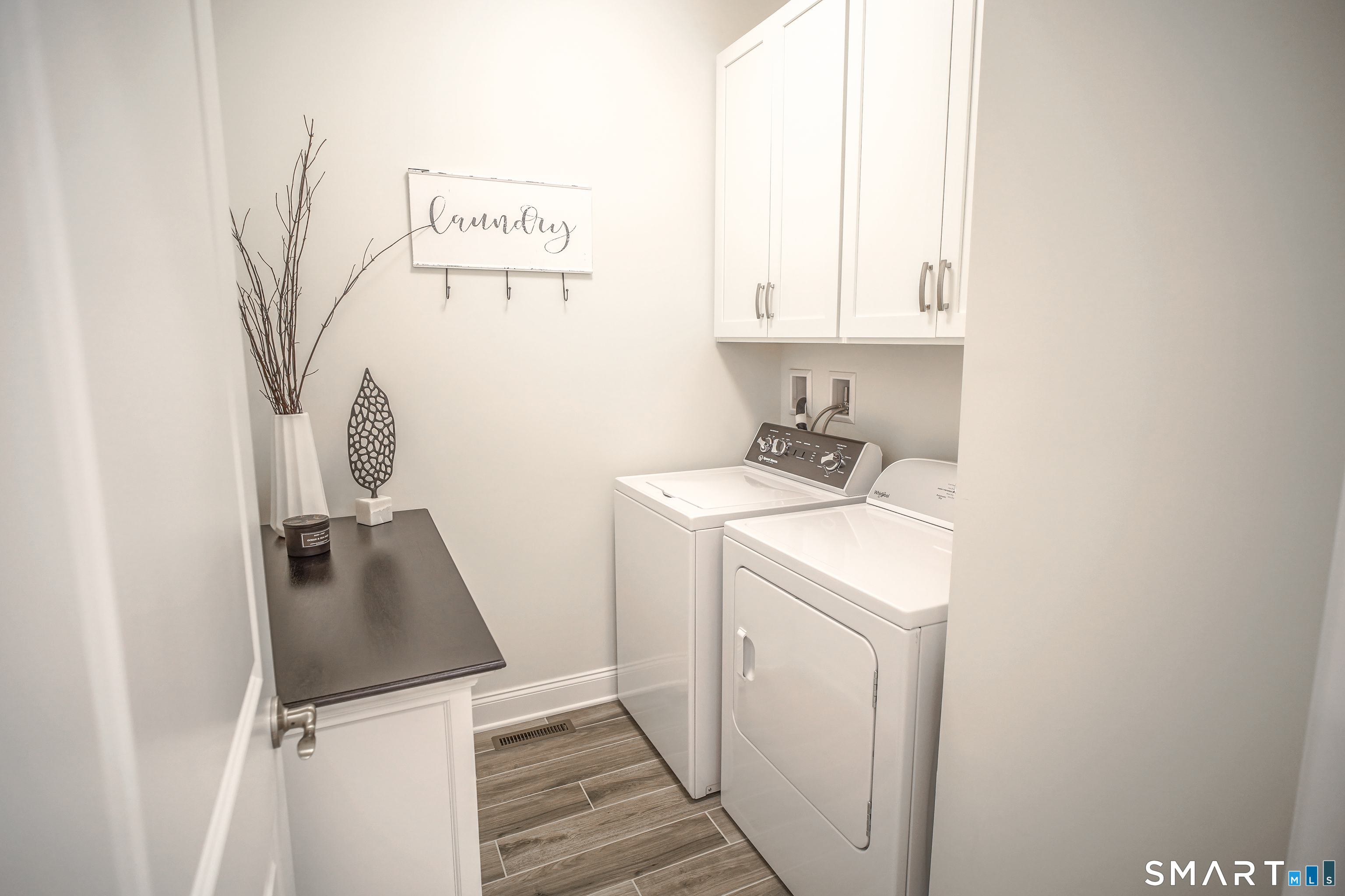28 Tamarack Court, Unit 28 Prospect, CT 06712 - Photo 40 of 40 This custom floor plan offers a separate laundry room with additional cabinets. Located off the kitchen to the garage hallway.
