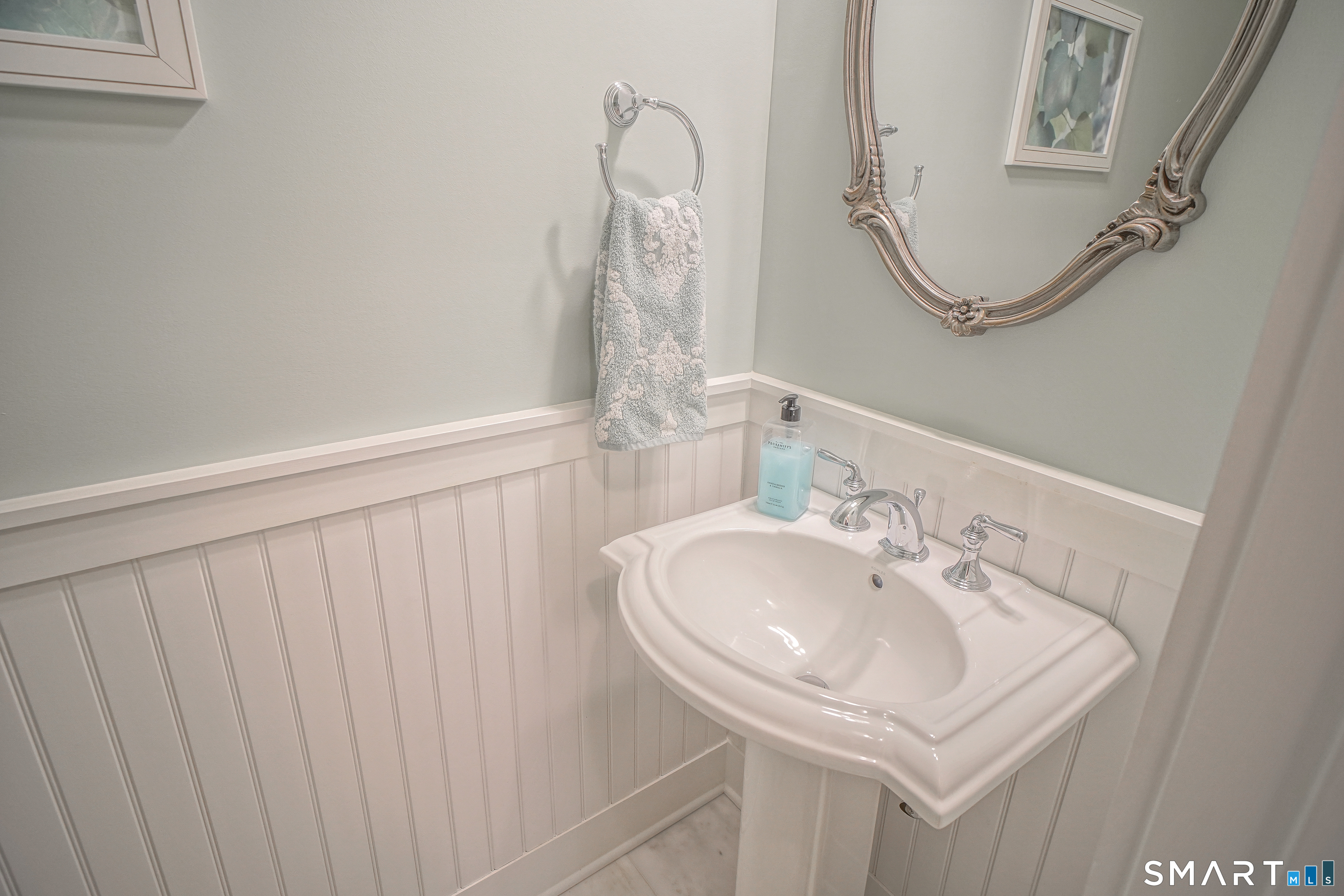 28 Tamarack Court, Unit 28 Prospect, CT 06712 - Photo 21 of 40 First floor guest baahroom with waincoating and title floors.