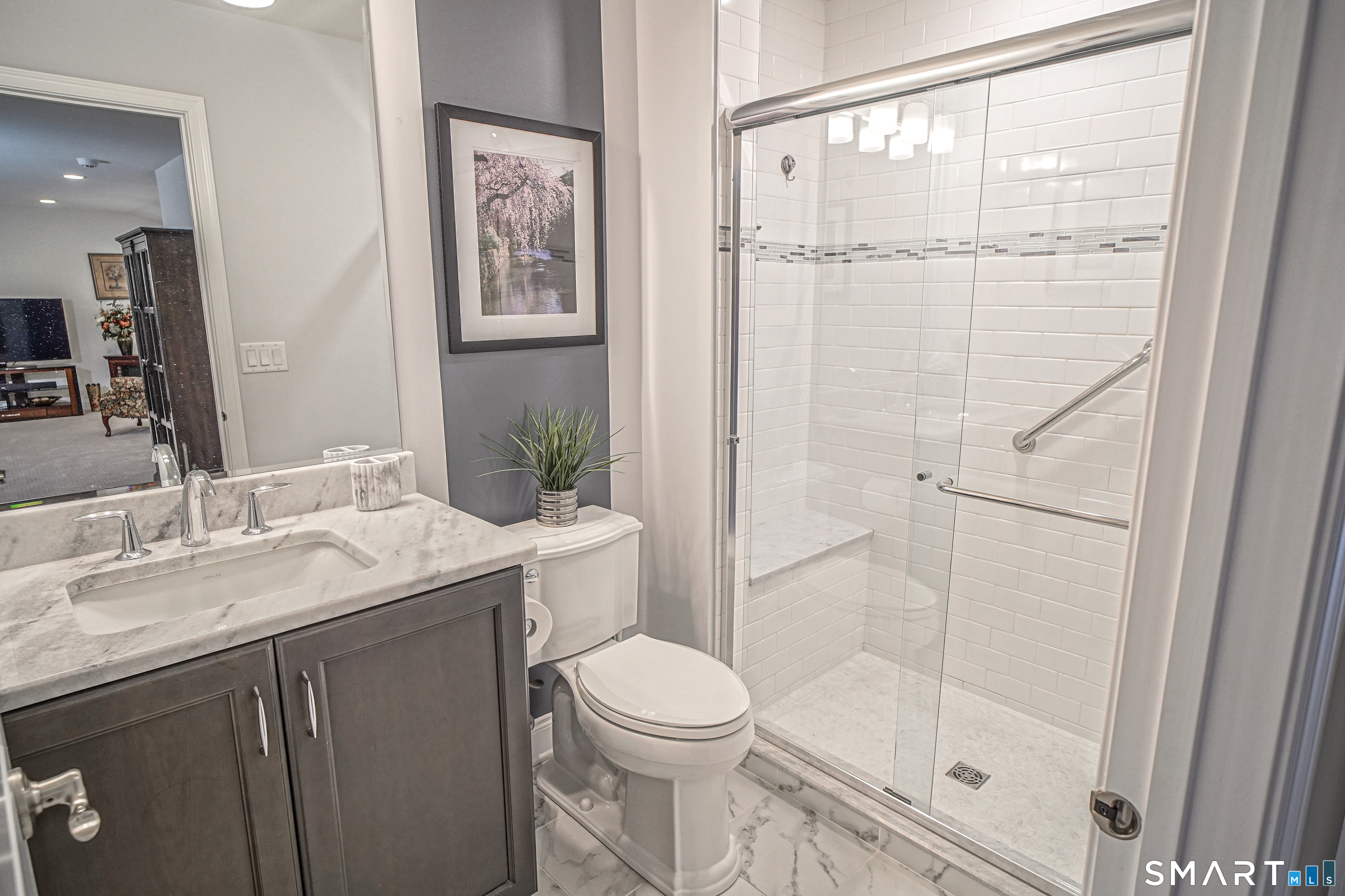 28 Tamarack Court, Unit 28 Prospect, CT 06712 - Photo 27 of 40 Upper-level full bath with tasteful finishing touches: glass shower doors, a raised high commode, marble countertops on vanity, and upgraded faucets.