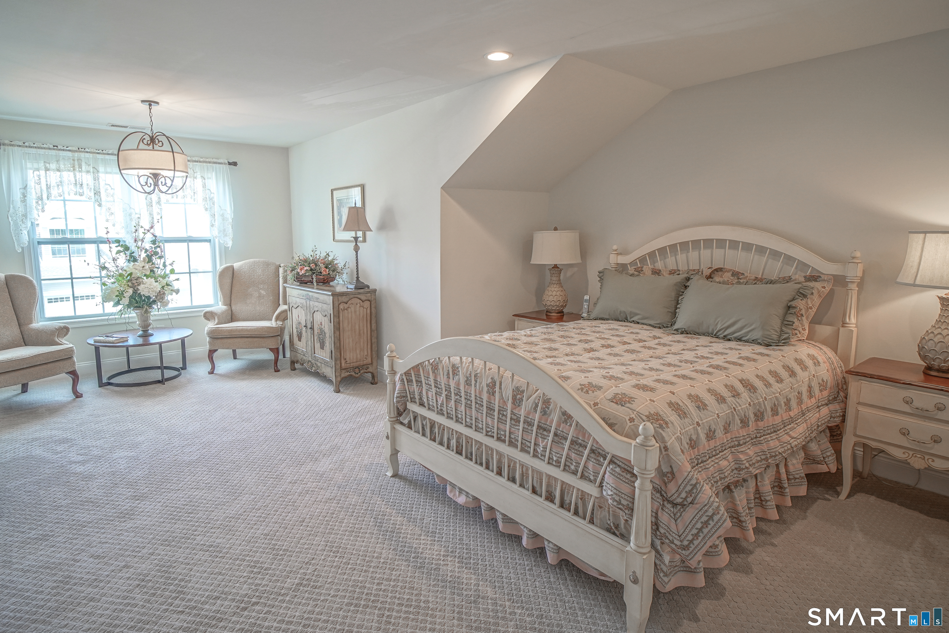 28 Tamarack Court, Unit 28 Prospect, CT 06712 - Photo 28 of 40 Upper-level spacious bedroom with sitting area and walk-in closet. This is a spacious upper-level bedroom that features a sitting area and a walk-in closet.