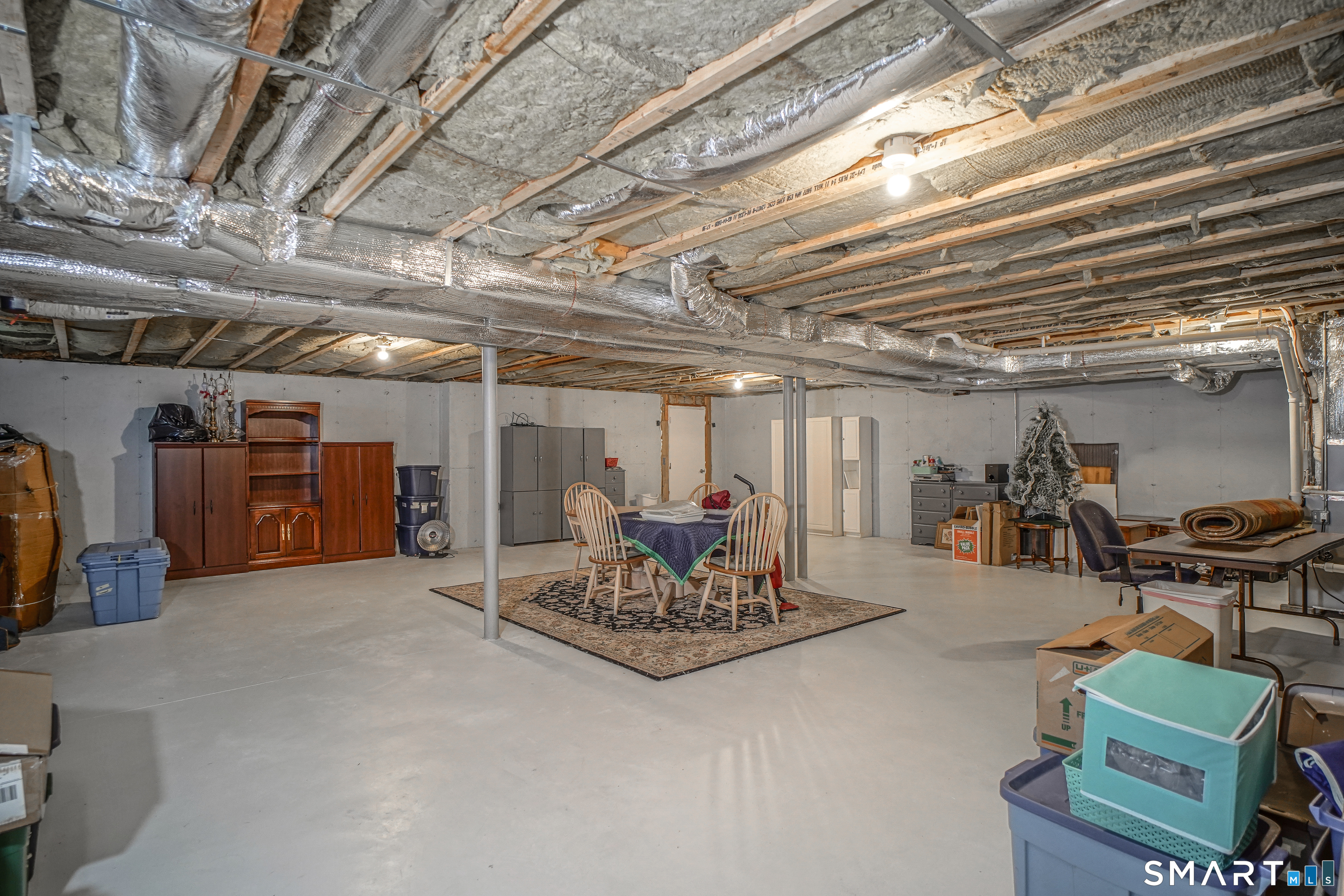 28 Tamarack Court, Unit 28 Prospect, CT 06712 - Photo 30 of 40 Painted floors in a spacious basement with plenty of storage room