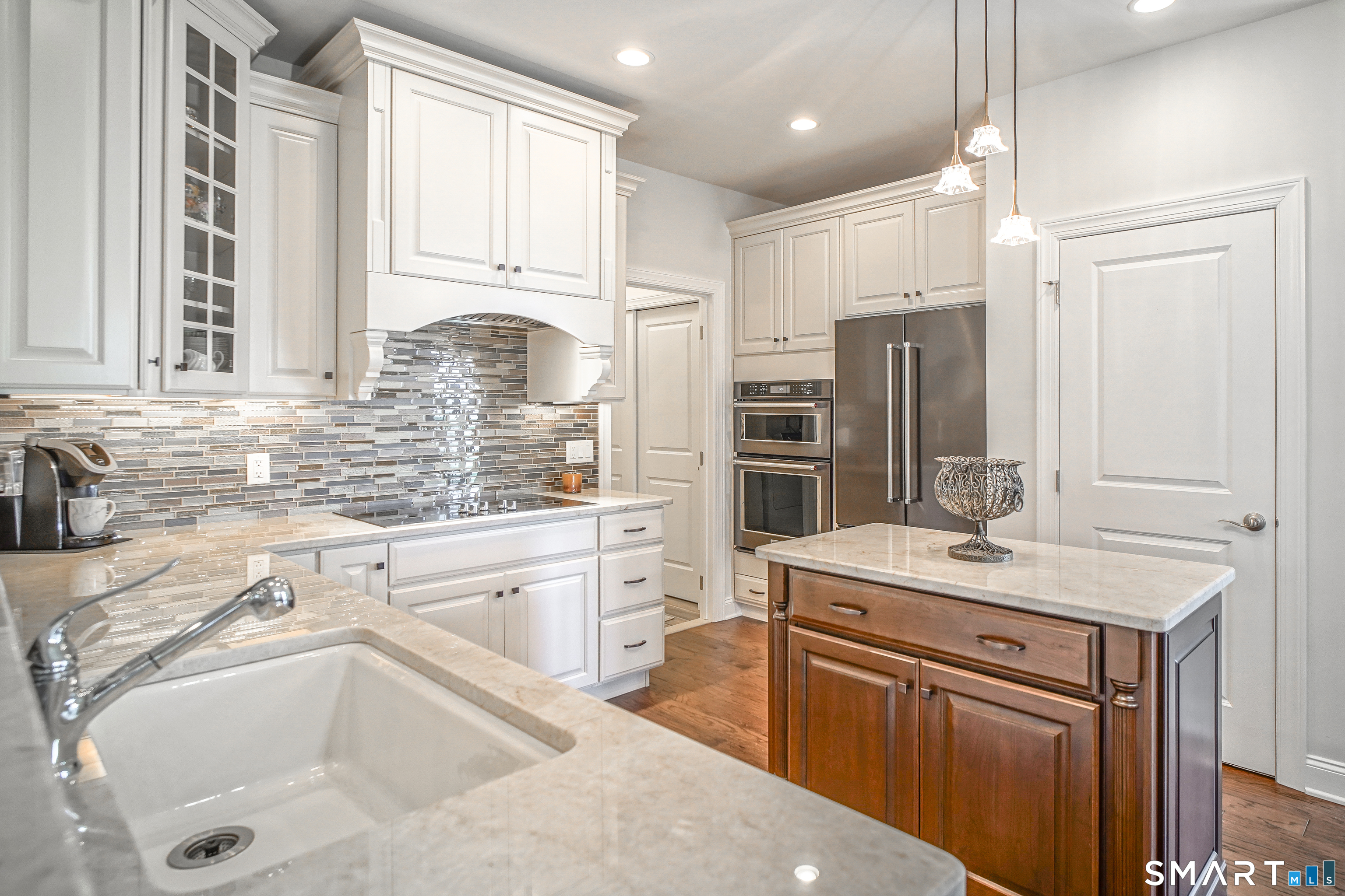 28 Tamarack Court, Unit 28 Prospect, CT 06712 - Photo 6 of 40 Premium Finishes: Beveled-edge quartzite countertops, a large single sink, and a center island with rollout drawers. Elegant Lighting: Beautiful pendant lighting complemented by additional designer ceiling lights.