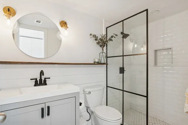 a bathroom with a toilet sink and shower