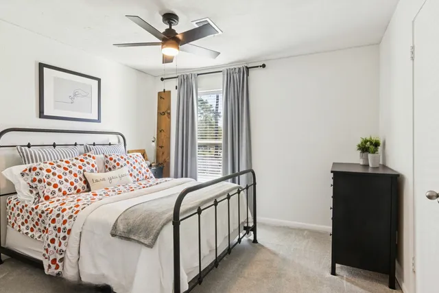 a bedroom with a bed and a chandelier
