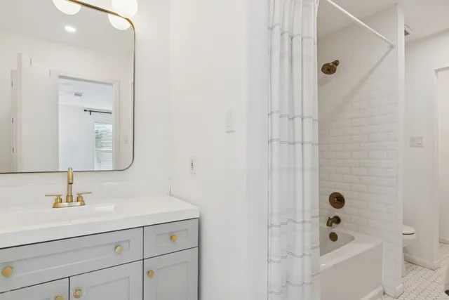 a bathroom with a bathtub a sink a vanity and a shower