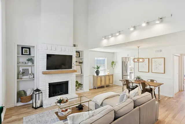 a living room with furniture a fireplace and a flat screen tv