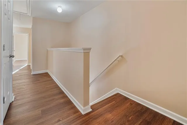 a view of hallway with wooden floor