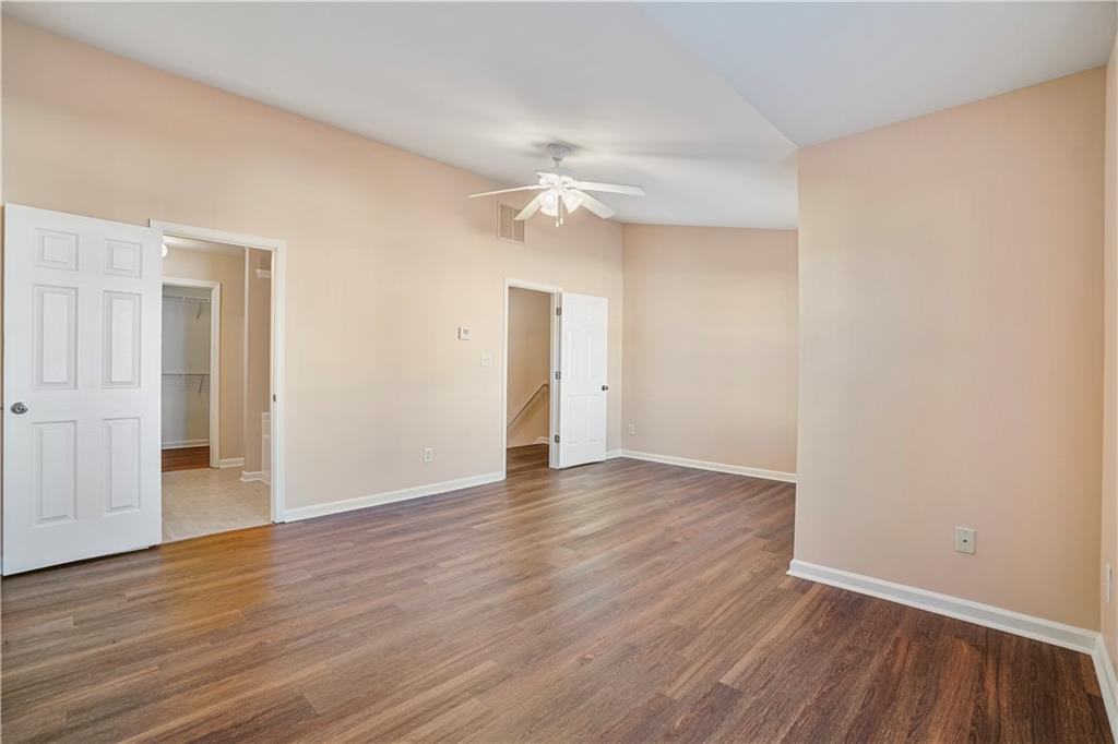 1938 Dilcrest Drive Duluth, GA 30096 - Photo 17 of 32 wooden floor in an empty room with a window