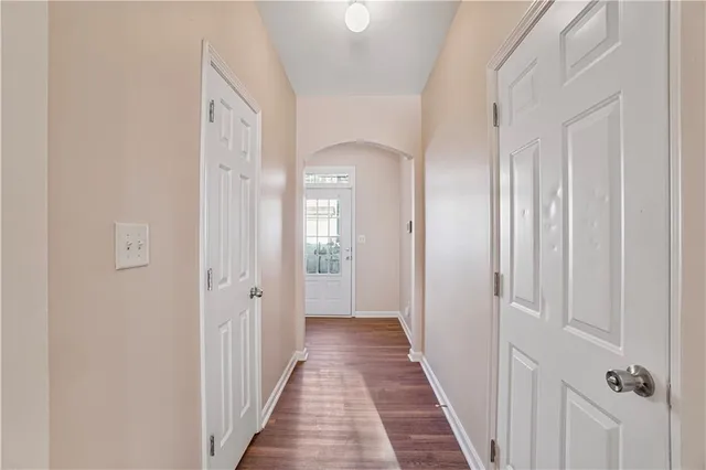 a view of a hallway with a wooden door