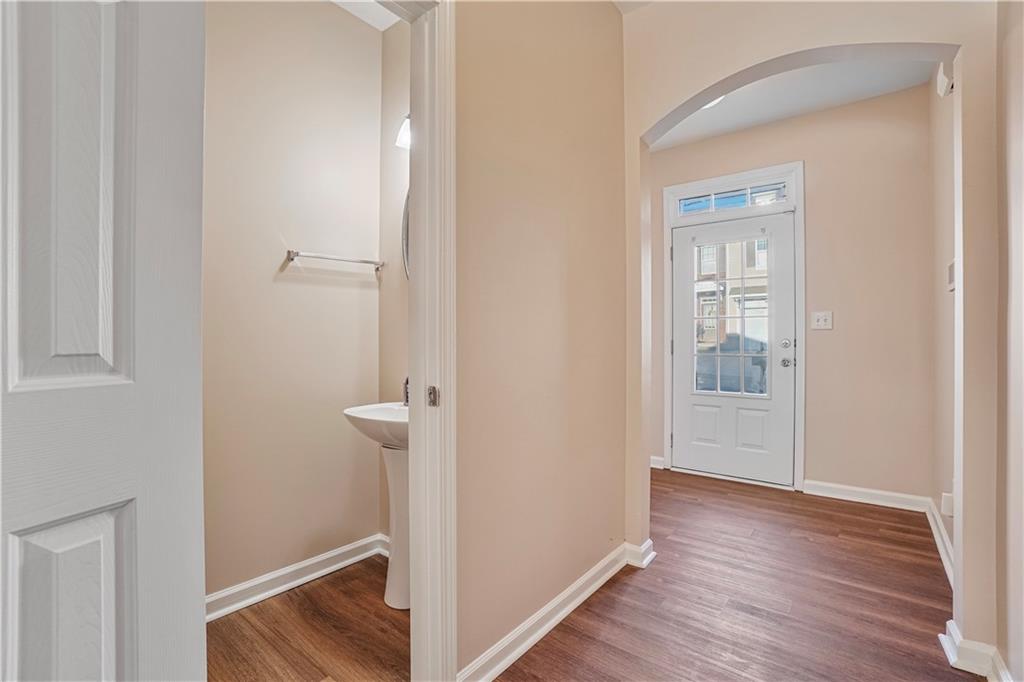 1938 Dilcrest Drive Duluth, GA 30096 - Photo 5 of 32 a view of a hallway with wooden floor and a bathroom