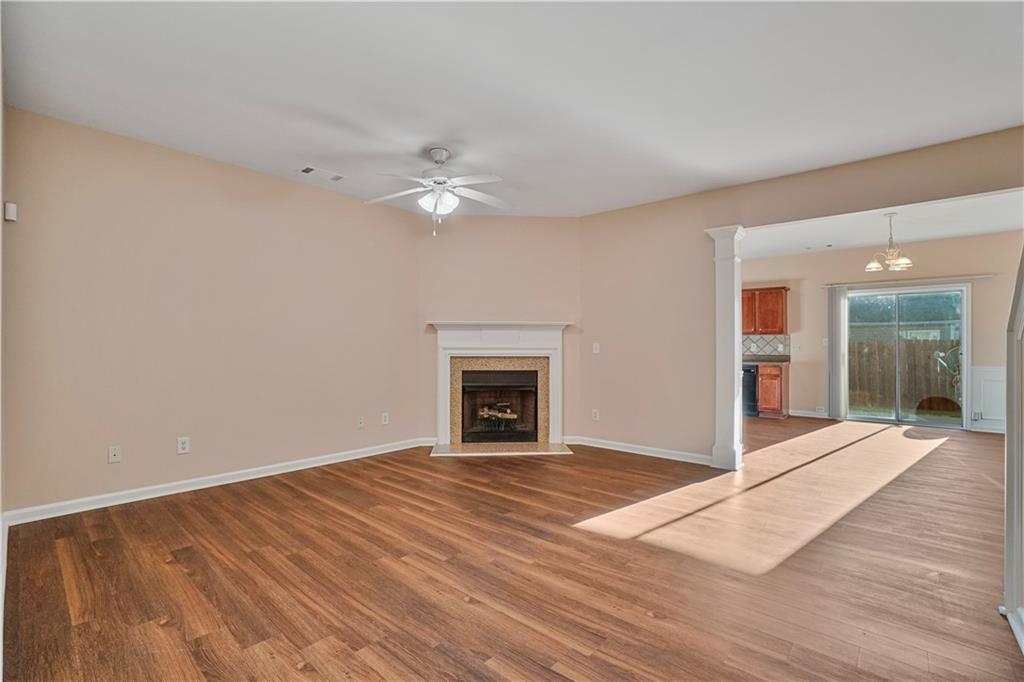 1938 Dilcrest Drive Duluth, GA 30096 - Photo 7 of 32 a view of an empty room with wooden floor fireplace and a window