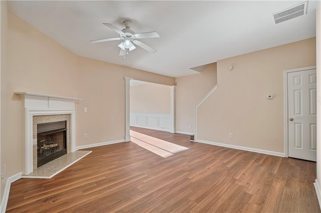 1938 Dilcrest Drive Duluth, GA 30096 - Photo 8 of 32 a view of an empty room with wooden floor and a fireplace
