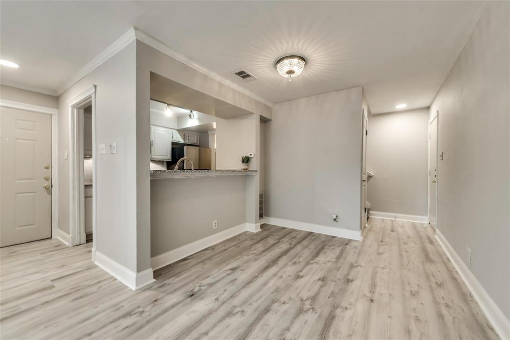 18240 Midway Road, Unit 302 Dallas, TX 75287 - Photo 8 of 33 a view of a kitchen with wooden floor and a sink