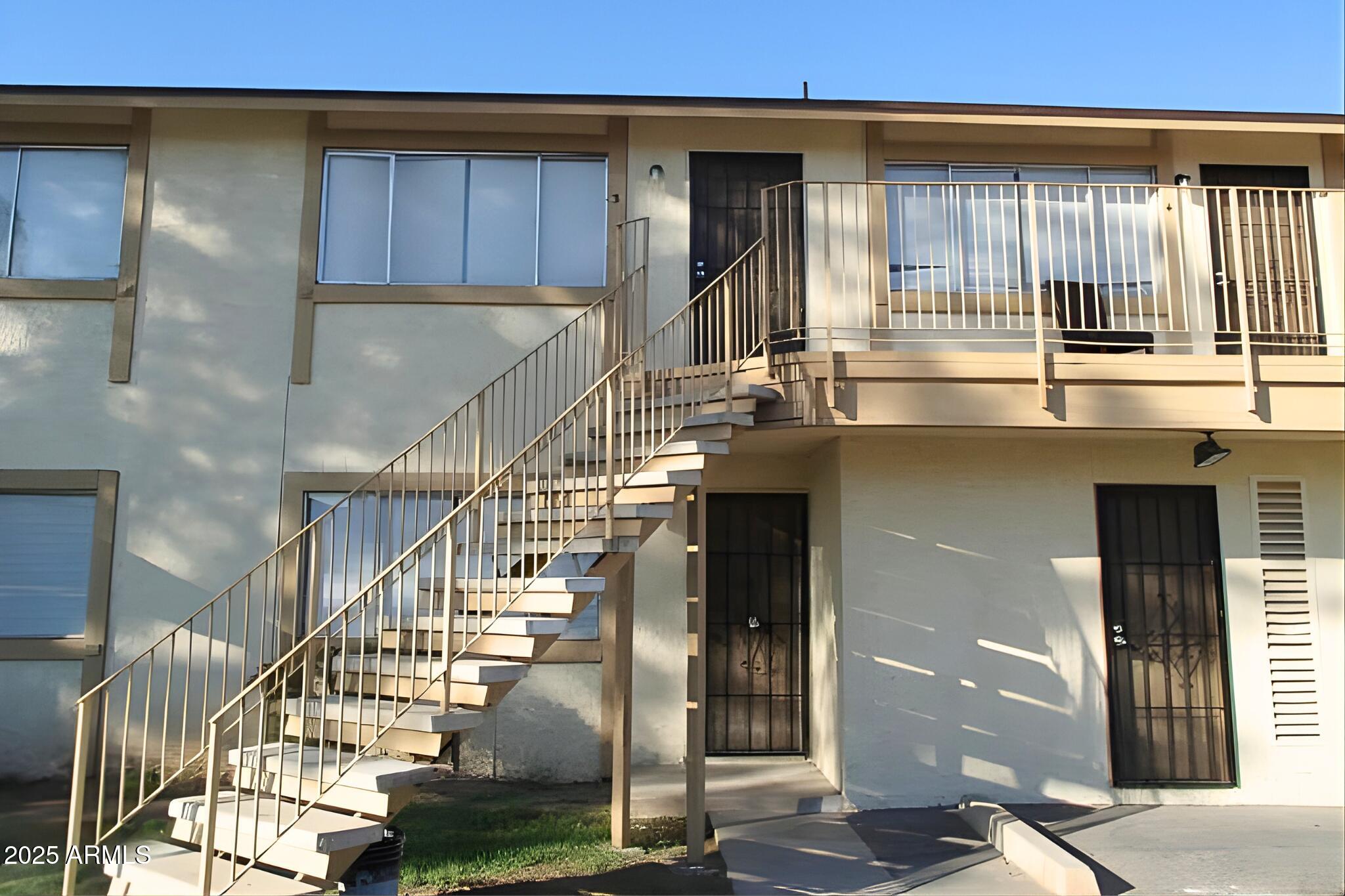 3313 West Harmont Drive, Unit 3 Phoenix, AZ 85051 - Photo 1 of 7 a kitchen with lots of counter top and windows