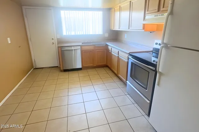a kitchen with stainless steel appliances a sink and a cabinets