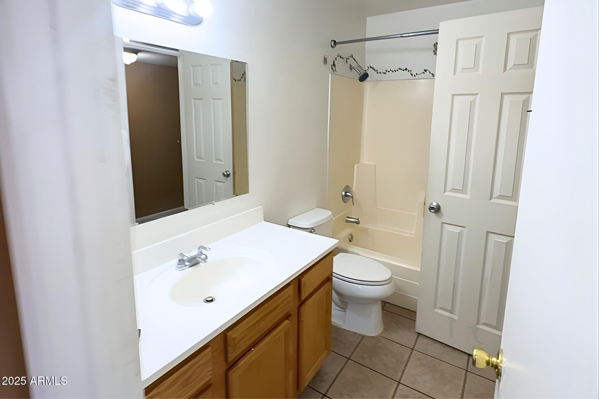 3313 West Harmont Drive, Unit 3 Phoenix, AZ 85051 - Photo 5 of 7 a bathroom with a sink and a toilet